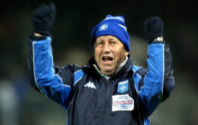 Guy Roux, coach of French team Auxerre waves at the crowd after his team defeated [Dutch team Utrech..